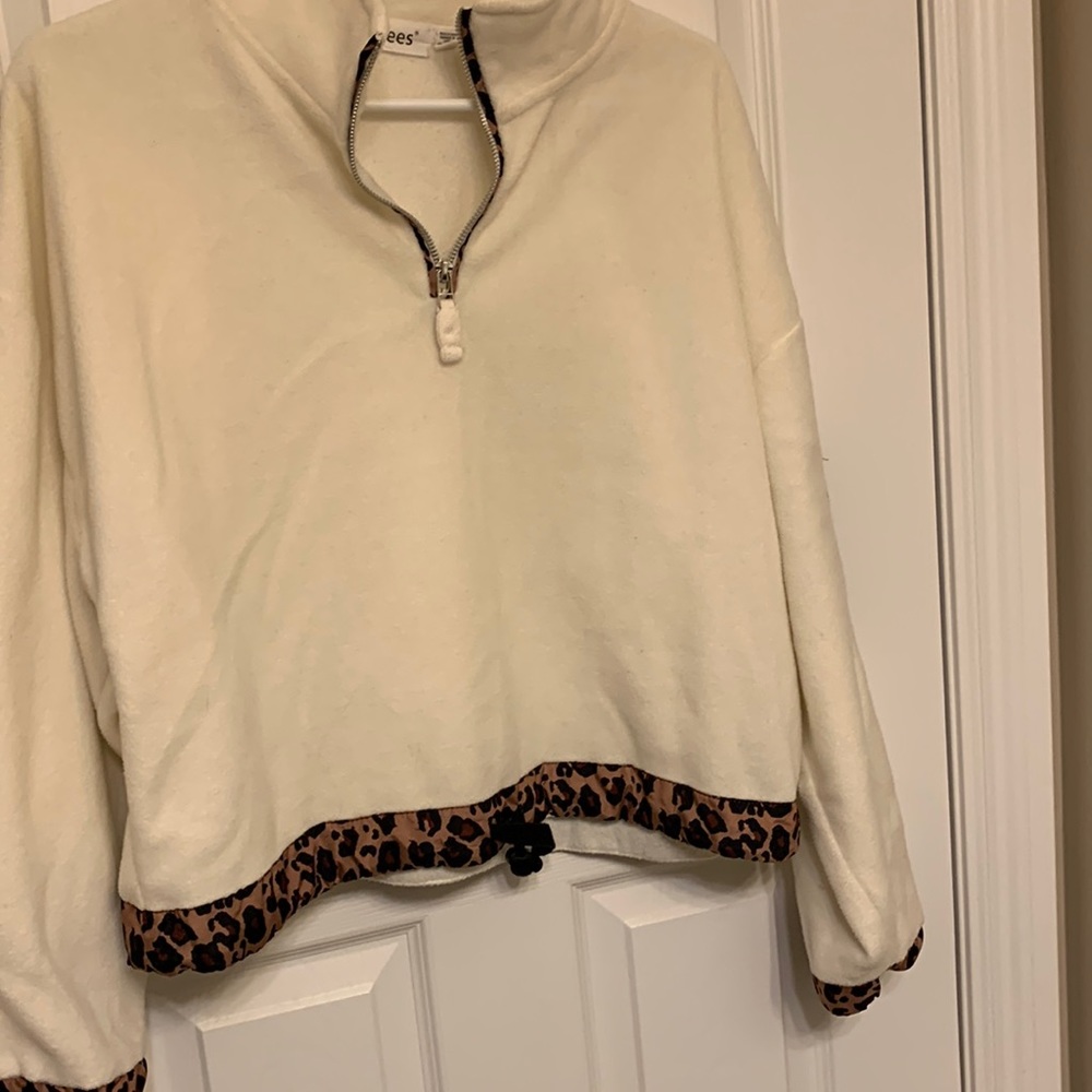 Fleece sweat top with leopard print on sleeve cuff, bottom